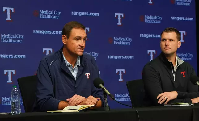 Texas Rangers president of baseball operations Chris Young, left, speaks as general manager Ross Fenstermaker looks on during an end of regular season baseball news conference, Friday, Oct. 3, 2025, in Arlington, Texas. (AP Photo/LM Otero)