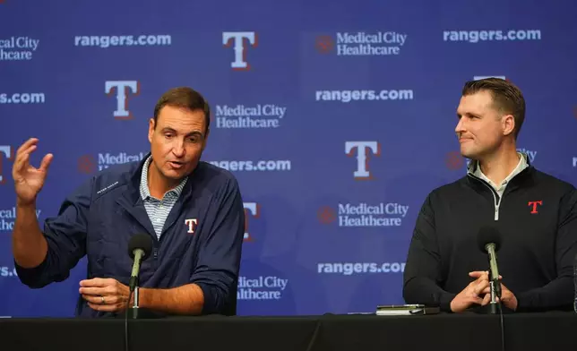 Texas Rangers president of baseball operations Chris Young, left, speaks as general manager Ross Fenstermaker looks on during an end of regular season baseball news conference, Friday, Oct. 3, 2025, in Arlington, Texas. (AP Photo/LM Otero)