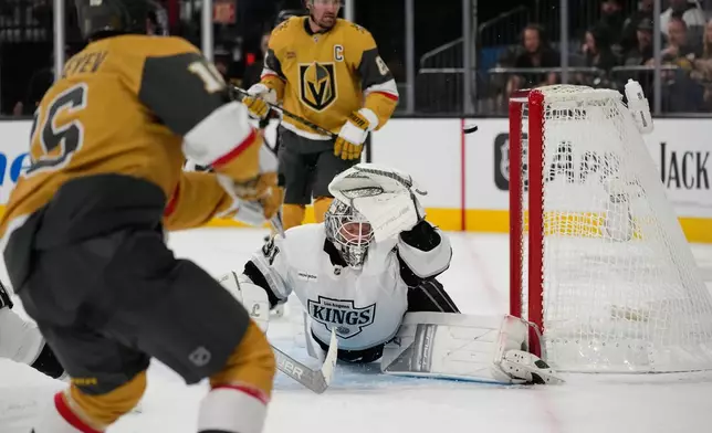 Vegas Golden Knights right wing Pavel Dorofeyev, left, scores his third goal of the game against Los Angeles Kings goaltender Anton Forsberg (31) during the second period of an NHL hockey game Wednesday, Oct. 8, 2025, in Las Vegas. (AP Photo/John Locher)