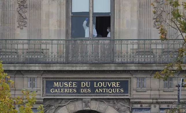 Police officers work inside the Louvre museum, Sunday, Oct. 19, 2025 in Paris. (AP Photo/Thibault Camus)