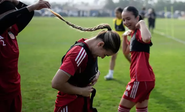 Members of Afghan Women United soccer team share a moment during a training session ahead of their first international tournament since fleeing their country, in Casablanca, Morocco, Saturday, Oct. 25, 2025. (AP Photo/Mosa'ab Elshamy)