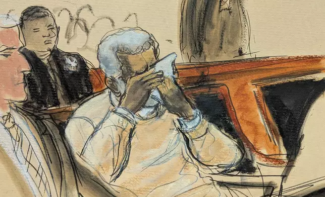 In this courtroom sketch, Sean Diddy Combs breaks down and cries during the playing of a video about his life during his sentencing hearing in Manhattan federal court, Friday, Oct. 3, 2025, in New York. (Elizabeth Williams via AP)