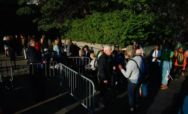 People wait outside to enter Manhattan federal court for the sentencing of Sean "Diddy" Combs in New York, Friday, Oct. 3, 2025. (AP Photo/Eduardo Munoz Alvarez)