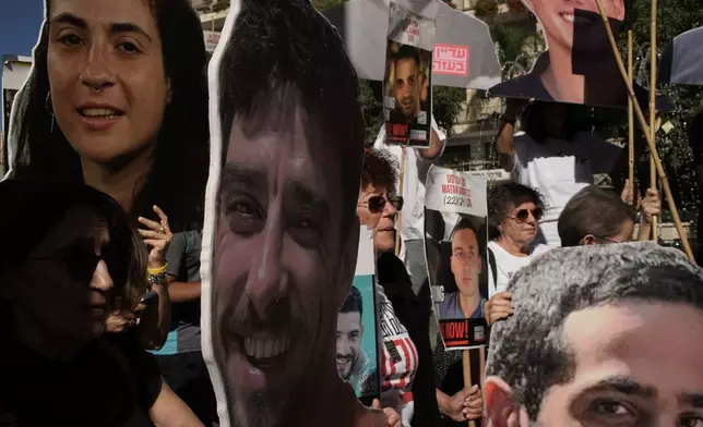 Relatives and supporters of Israeli hostages held by Hamas in the Gaza Strip carry posters with portraits of their loved ones during a protest demanding their immediate release and calling for a ceasefire, in Jerusalem, Tuesday, Oct. 7, 2025, on the second anniversary of Hamas' cross-border attack on Israel on Oct. 7, 2023, which sparked the ongoing war in Gaza. (AP Photo/Leo Correa)