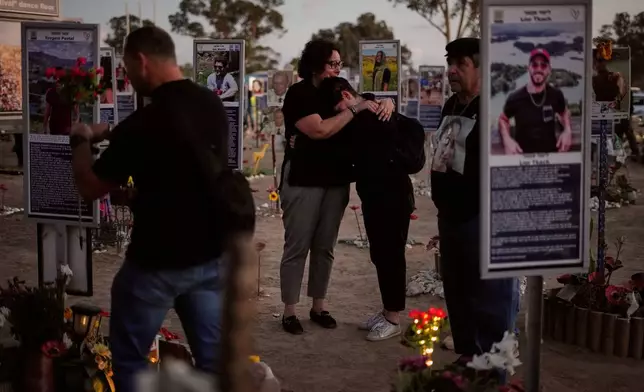 People visit the site of the Nova music festival, where hundreds of revelers were killed and abducted by Hamas and taken into Gaza, as Israel marks the second year anniversary of the attack, near Kibbutz Reim, southern Israel, Tuesday, Oct. 7, 2025. (AP Photo/Ariel Schalit)