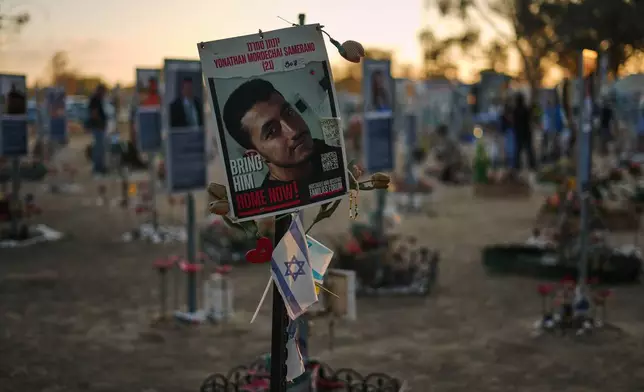 A photo of Yonathan Samerano, who was killed in the Hamas cross-border attack on Israel on Oct. 7, 2023, is seen in the site of the Nova music festival, where hundreds of revelers were killed and abducted by Hamas, as Israel marks the second year anniversary of the attack, near Kibbutz Reim, southern Israel, Tuesday, Oct. 7, 2025. (AP Photo/Ariel Schalit)