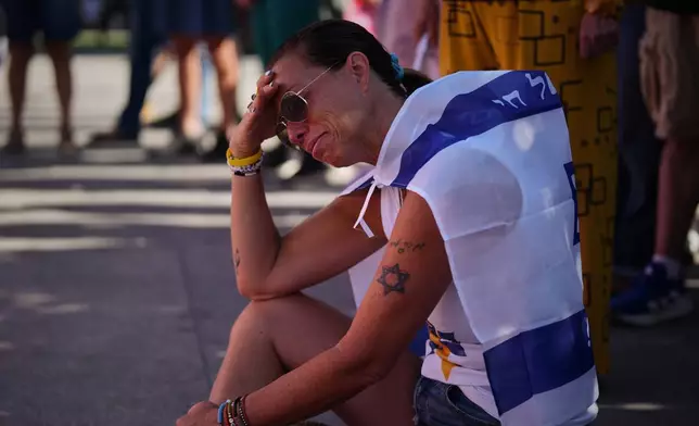Shiri Tamam, an Israeli Canadian reacts during a memorial marking two years anniversary of the deadly Oct. 7, 2023 Hamas attack on Israel, in Tel Aviv, Israel, Tuesday, Oct. 7, 2025. (AP Photo/Emilio Morenatti)