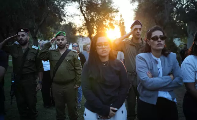 People attend a memorial service marking two years since the Oct. 7, 2023, Hamas cross-border attack on Israel, in Kibbutz Kfar Aza, southern Israel where many of its community members were Killed and abducted, Tuesday, Oct. 7, 2025. (AP Photo/Ohad Zwigenberg)