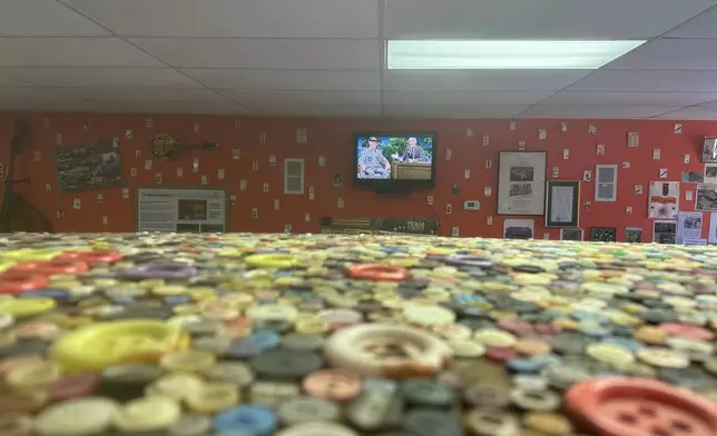 Dalton Stevens' button hearse is seen along with video of his appearance on "The Tonight Show Starring Johnny Carson" in his museum in Bishopville, S.C., on Tuesday, Sept. 9, 2025. (AP Photo/Jeffrey Collins)
