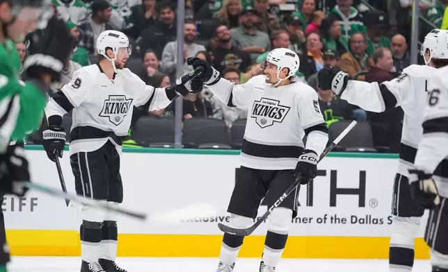 Los Angeles Kings defenseman Cody Ceci (5) celebrates scoring a goal with teammate right wing Adrian Kempe (9) during the second period of an NHL hockey game against the Dallas Stars Thursday, Oct. 23, 2025, in Dallas. (AP Photo/LM Otero)