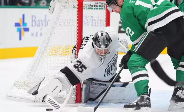 Los Angeles Kings goaltender Darcy Kuemper (35) defends the goal against Dallas Stars center Radek Faksa (12) during the first period of an NHL hockey game Thursday, Oct. 23, 2025, in Dallas. (AP Photo/LM Otero)