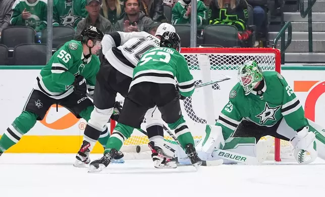 Los Angeles Kings right wing Corey Perry (10) scores a goal against Dallas Stars defenders Thomas Harley (55), Wyatt Johnston (53) and goaltender Jake Oettinger (29) during the first period of an NHL hockey game Thursday, Oct. 23, 2025, in Dallas. (AP Photo/LM Otero)