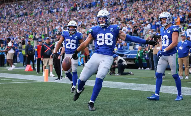 Seattle Seahawks tight end AJ Barner (88) celebrates after scoring a touchdown during the second half of an NFL football game against the Tampa Bay Buccaneers, Sunday, Oct. 5, 2025, in Seattle. (AP Photo/Maddy Grassy)