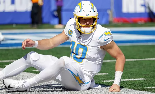 Los Angeles Chargers quarterback Justin Herbert (10) gets up off the turf after throwing an interception against the New York Giants during the first quarter of an NFL football game, Sunday, Sept. 28, 2025, in East Rutherford, N.J. (AP Photo/Adam Hunger)