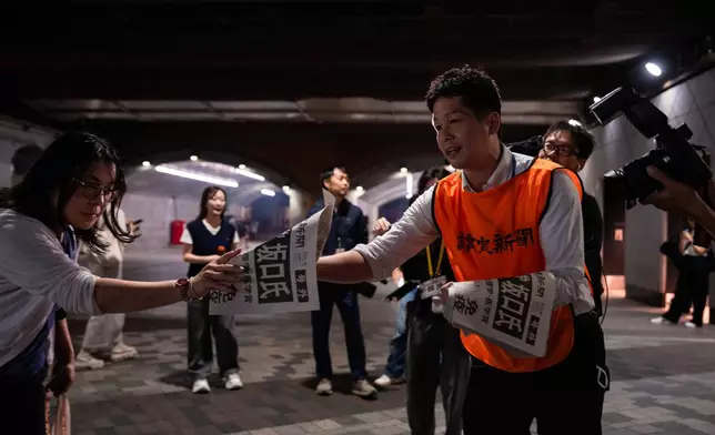 Staff from Japan's Yomiuri Shimbun distributes extra editions reporting on Japanese Dr. Shimon Sakaguchi winning the Nobel Prize in medicine, along with scientists Mary E. Brunkow and Fred Ramsdell, for their discoveries concerning peripheral immune tolerance, in Tokyo, Monday, Oct 6, 2025. (AP Photo/Louise Delmotte)