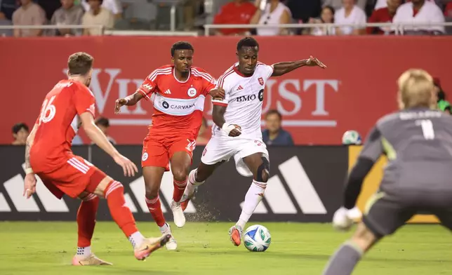 Chicago Fire midfielder Maren Haile-Selassie, center left, and Toronto FC defender Richie Laryea, center right, battle for control of the ball during the second half of an MLS soccer match Saturday, Oct. 4, 2025, in Chicago. (AP Photo/Talia Sprague)
