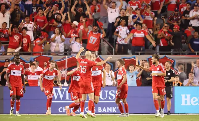 Chicago Fire players celebrate after a second-half goal against Toronto FC during an MLS soccer match Saturday, Oct. 4, 2025, in Chicago. (AP Photo/Talia Sprague)