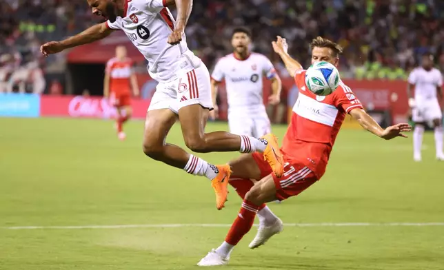 Chicago Fire midfielder Philip Zinckernagel, right, trips Toronto FC midfielder Kosi Thompson, left, during the first half of an MLS soccer match Saturday, Oct. 4, 2025, in Chicago. (AP Photo/Talia Sprague)