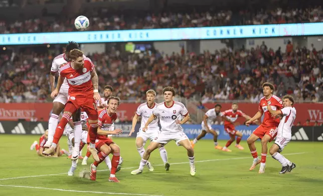 Chicago Fire center-back Joel Waterman, front left, and Toronto FC midfielder Matthew Longstaff, back left, battle for a header during the first half of an MLS soccer match Saturday, Oct. 4, 2025, in Chicago. (AP Photo/Talia Sprague)