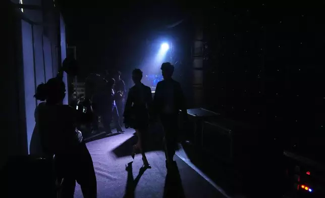 Models return back stage after a show during Lakmé Fashion Week in partnership with Fashion Design Council of India (FDCI) in New Delhi, India, Thursday, Oct. 9, 2025. (AP Photo/Manish Swarup)