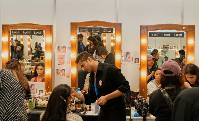 Models get ready for the Lakmé Fashion Week in partnership with Fashion Design Council of India or FDCI in New Delhi, India, Thursday, Oct. 9, 2025. (AP Photo/Manish Swarup)