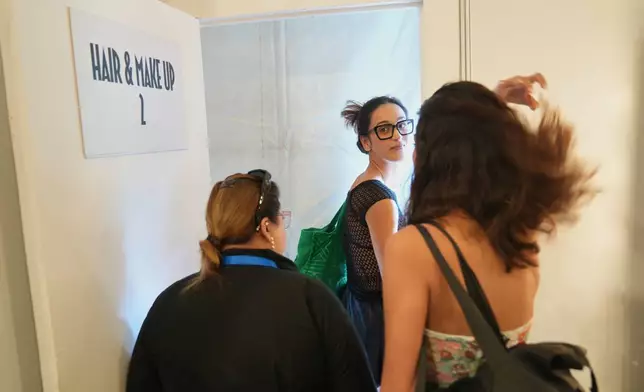 Models leave after getting hair and make for the Lakmé Fashion Week in partnership with Fashion Design Council of India or FDCI in New Delhi, India, Thursday, Oct. 9, 2025. (AP Photo/Manish Swarup)