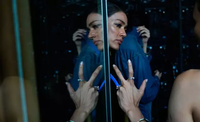 Models take a break back stage during a rehearsal at the Lakmé Fashion Week in partnership with Fashion Design Council of India or FDCI in New Delhi, India, Thursday, Oct. 9, 2025. (AP Photo/Manish Swarup)