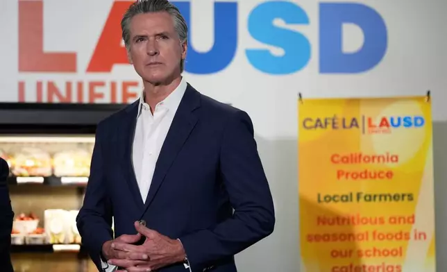 Gov. Gavin Newsom prepares to speak at a news conference at Belvedere Middle School, Wednesday, Oct. 8, 2025, in Los Angeles. (AP Photo/Damian Dovarganes)