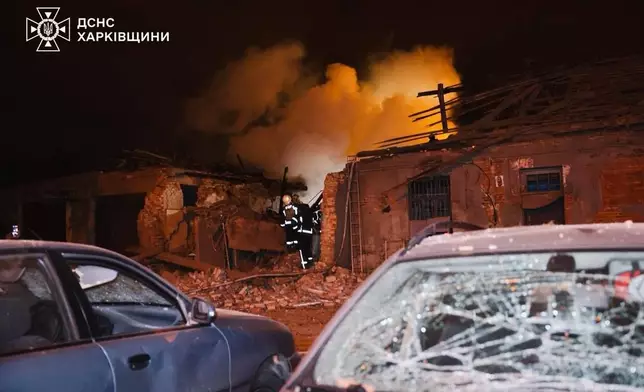 In this photo provided by the Ukrainian Emergency Services on Tuesday, Oct. 14, 2025, rescue workers put out a fire of a hospital damaged by a Russian strike in Kharkiv, Ukraine. (Ukrainian Emergency Service via AP)