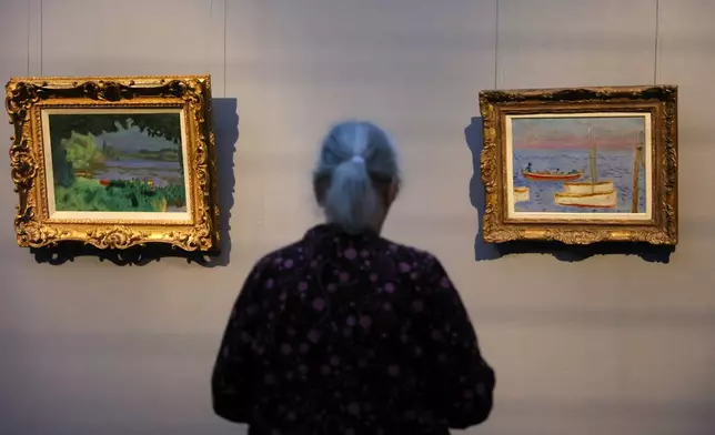 A visitor looks on the painting Lagoon on the Seine, left, and White Boots from Pierre Bonnard at a press preview for the exhibition "The Scharf Collection: Goya – Monet – Cezanne – Bonnard – Grosse" at the Alte Nationalgalerie museum in Berlin, Wednesday, Oct. 22, 2025. (AP Photo/Maryam Majd)
