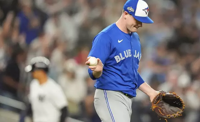 Toronto Blue Jays pitcher Louis Varland reacts after giving up a three-run home run to New York Yankees' Aaron Judge during the fourth inning of Game 3 of baseball's American League Division Series, Tuesday, Oct. 7, 2025, in New York. (AP Photo/Frank Franklin II)