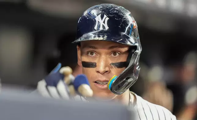 New York Yankees' Aaron Judge reacts in the dugout after hitting a three-run home run against the Toronto Blue Jays during the fourth inning of Game 3 of baseball's American League Division Series, Tuesday, Oct. 7, 2025, in New York. (AP Photo/Frank Franklin II)