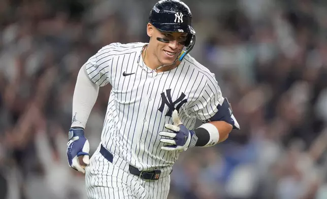 New York Yankees' Aaron Judge reacts as he rounds the bases after hitting a three-run home run against the Toronto Blue Jays during the fourth inning of Game 3 of baseball's American League Division Series, Tuesday, Oct. 7, 2025, in New York. (AP Photo/Frank Franklin II)