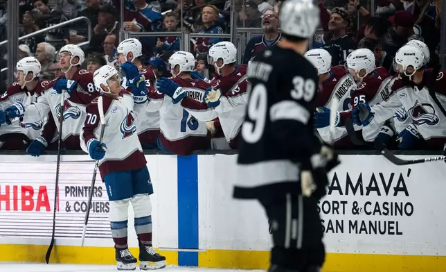 Colorado Avalanche defenseman Sam Malinski (70) celebrates his goal with the bench during the second period of an NHL hockey game against the Los Angeles Kings, Tuesday, Oct. 7, 2025, in Los Angeles. (AP Photo/Kyusung Gong)