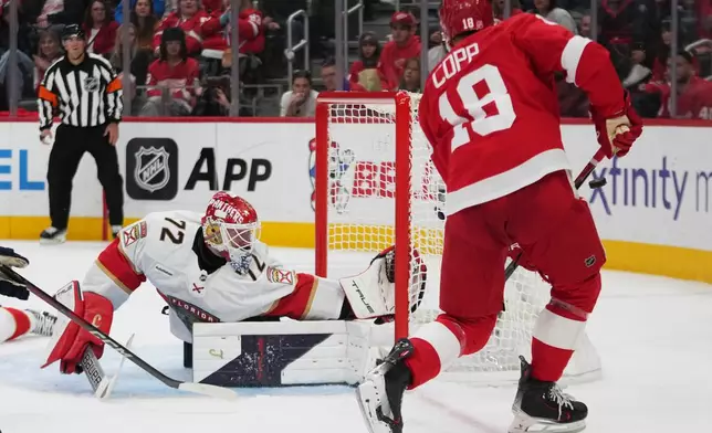 Florida Panthers goaltender Sergei Bobrovsky (72) deflects a Detroit Red Wings center Andrew Copp (18) shot in the second period of an NHL hockey game Wednesday, Oct. 15, 2025, in Detroit. (AP Photo/Paul Sancya)