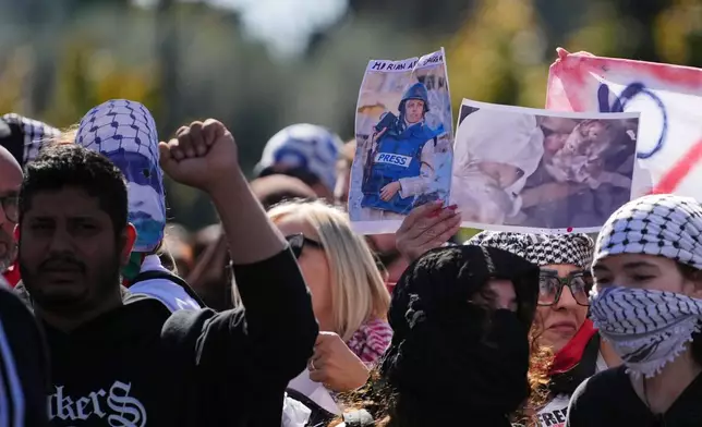 Pro Palestinian demonstrators hold up a photograph of Mariam Dagga, a visual journalist who freelanced for The Associated Press, killed in an Israeli strike in August, as they march during a national demonstration in support of the population of Gaza, in Rome, Saturday, Oct. 4, 2025. (AP Photo/Alessandra Tarantino)
