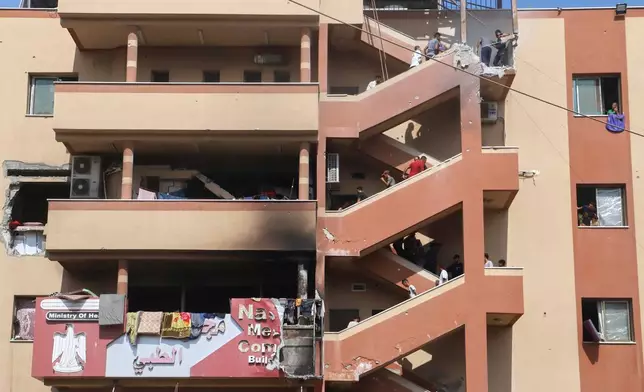 FILE - People walk up stairs to the site of an Israeli strike at Nasser Hospital, minutes before a second round of strikes hit the same spot in Khan Younis, Gaza Strip, Monday, Aug. 25, 2025. This was one of the last photos taken by journalist Mariam Dagga, who freelanced for The Associated Press and other outlets, before she walked to the site and was killed. (AP Photo/Mariam Dagga, File)