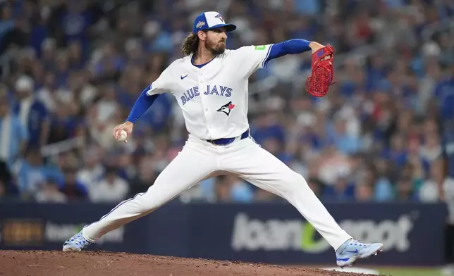 Toronto Blue Jays pitcher Kevin Gausman delivers against the Seattle Mariners during the seventh inning in Game 7 of baseball's American League Championship Series in Toronto, Monday, Oct. 20, 2025. (Nathan Denette/The Canadian Press via AP)