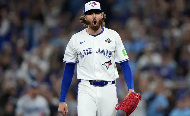 Toronto Blue Jays pitcher Kevin Gausman (34) celebrates retiring the Los Angeles Dodgers during the fourth inning in Game 2 of baseball's World Series, Saturday, Oct. 25, 2025, in Toronto. (Nathan Denette/The Canadian Press via AP)