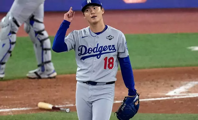 Los Angeles Dodgers' pitcher Yoshinobu Yamamoto celebrates his complete game after Game 2 of baseball's World Series against the Toronto Blue Jays, Saturday, Oct. 25, 2025, in Toronto. (AP Photo/David J. Phillip)