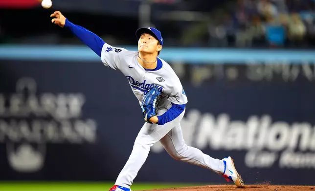 Los Angeles Dodgers pitcher Yoshinobu Yamamoto (18) delivers against the Toronto Blue Jays during the first inning in Game 2 of baseball's World Series, Saturday, Oct. 25, 2025, in Toronto. (Frank Gunn/The Canadian Press via AP)