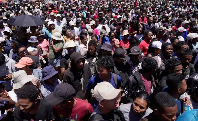 Protesters listen to speeches during a protest calling for President Andry Rajoelina to step down in Antananarivo, Madagascar, Tuesday, Oct. 14, 2025. (AP Photo/Brian Inganga)