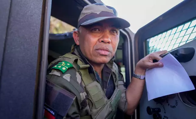 CAPSAT military unit commander Col. Michael Randrianirina and his troops make their way to the Presidency to announce that the armed forces are taking control of the country in Antananarivo, Madagascar, Tuesday, Oct. 14, 2025. (AP Photo/Brian Inganga)