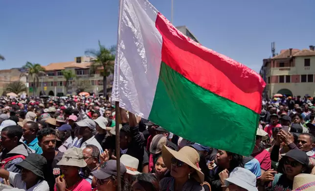 Protesters listen to speeches during a protest calling for President Andry Rajoelina to step down in Antananarivo, Madagascar, Tuesday, Oct. 14, 2025. (AP Photo/Brian Inganga)