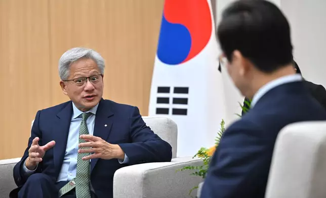 South Korean President Lee Jae Myung, right, talks with Nvidia CEO Jensen Huang during their meeting on the sidelines of the Asia-Pacific Economic Cooperation (APEC) summit in Gyeongju, South Korea Friday, Oct. 31, 2025. (Jung Yeon-je/Pool Photo via AP)