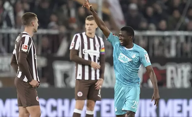 Hoffenheim's Bazoumana Toure, right, celebrates scoring during the Bundesliga soccer match between FC St. Pauli and TSG 1899 Hoffenheim in Hamburg, Germany, Sunday Oct. 19, 2025. (Marcus Brandt/dpa via AP)