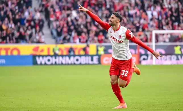 SC Freiburg's Vincenzo Grifo celebrates scoring a goal, during a German Bundesliga soccer match between SC Freiburg and Eintracht Frankfurt, in Freiburg im Breisgau, Germany, Sunday, Oct. 19, 2025. (Harry Langer/dpa via AP)