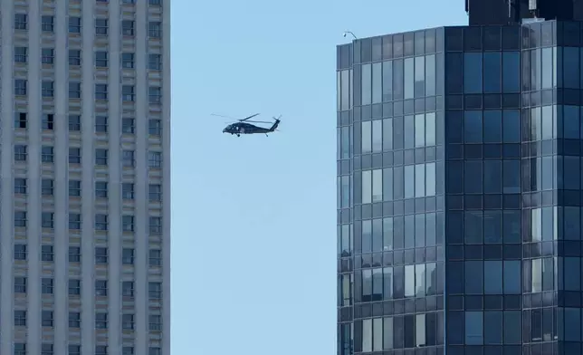 A Blackhawk helicopter flies over the skyline in Memphis, Tenn., Wednesday, Oct. 8, 2025. (AP Photo/George Walker IV)