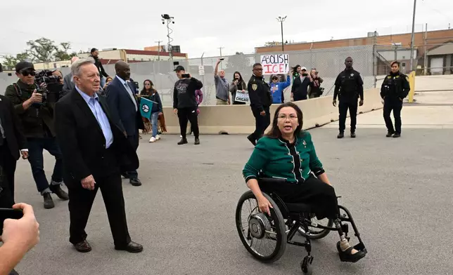 Sen. Tammy Duckworth, D-Ill., and Sen. Dick Durbin, D-Ill., speak to protestors outside the U.S. Immigration and Customs Enforcement facility in Broadview, Ill., Friday, Oct. 10, 2025. (AP Photo/Paul Beaty)