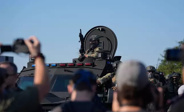 Federal law enforcement arrive near an Immigration and Customs Enforcement facility in Broadview, Ill., Friday, Oct. 3, 2025. (AP Photo/Erin Hooley)